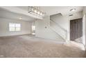 Bright living room with neutral carpet, white walls, and a staircase leading to the upper level at 2324 Boneset Dr, Plainfield, IN 46168