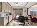 Sunny dining area with modern wood floors, trim, ceiling fan, and natural light streaming in from a large picture window at 2437 W Wavelyn N Cir, Martinsville, IN 46151