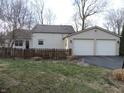 Exterior showcasing the backyard, detached two-car garage, and a classic wooden fence at 269 Iron Bridge Rd, Cicero, IN 46034