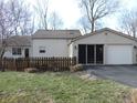 View of the home's exterior featuring a picket fence and a two car garage at 269 Iron Bridge Rd, Cicero, IN 46034