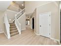 Staircase, hardwood floors, and natural lighting enhance the living space's appeal at 269 Wakefield E Dr, Greenwood, IN 46142