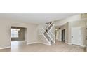 Bright foyer with hardwood floors, a staircase, and neutral paint, creating a welcoming entrance at 269 Wakefield E Dr, Greenwood, IN 46142