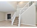 Staircase featuring neutral carpeting, white handrails, and an open floor plan at 269 Wakefield E Dr, Greenwood, IN 46142