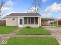 Charming single-story home featuring a well-maintained lawn and convenient covered parking at 329 Roosevelt Dr, Shelbyville, IN 46176