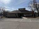 Community clubhouse featuring welcoming entrance, ample parking, and manicured landscaping at 4470 Village Ln # 3, Indianapolis, IN 46254