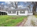 Quaint single-story home with an asphalt driveway and detached garage at 6 Helena Ct, Indianapolis, IN 46222