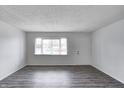 Bright living room with hardwood floors, fresh paint, and a large window at 6 Helena Ct, Indianapolis, IN 46222
