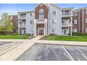 Multi-story condo building featuring balconies, attractive siding, and landscaped surroundings at 6231 Amber Creek Ln # 312, Indianapolis, IN 46237