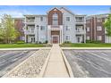 Three-story condo building with balconies, set amidst green landscaping and convenient parking at 6231 Amber Creek Ln # 312, Indianapolis, IN 46237
