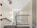 Well-maintained staircase with carpeted steps and sturdy railings, leading to upper floors at 6231 Amber Creek Ln # 312, Indianapolis, IN 46237