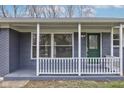 Close up of the home's welcoming covered front porch and leaded glass door at 6503 W 15Th St, Indianapolis, IN 46214