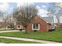 Well-maintained brick home featuring a trimmed lawn, mature trees and an attached two car garage at 6628 Moss Cir, Indianapolis, IN 46237
