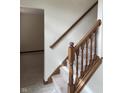 Classic staircase with carpeted steps and stained wood banister leading to the upper level at 6816 Russett Dr, Plainfield, IN 46168