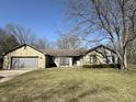 Charming single-story home featuring a stone facade and attached garage, set on a spacious lot with mature trees at 7164 Sandalwood Dr, Avon, IN 46123