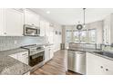 Well-lit kitchen features stainless steel appliances, granite countertops, and a breakfast bar at 7254 Cambridge Pl, Avon, IN 46123