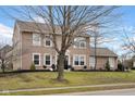 Traditional home with well-maintained lawn and landscaping, enhancing its curb appeal on a sunny day at 7383 Poppyseed Dr, Indianapolis, IN 46237