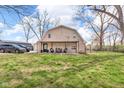 View of backyard with lush grass, storage shed, and a fence at 7845 Bluff Rd, Indianapolis, IN 46217