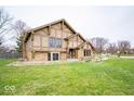 Angle view of this cozy two-story home with stone and stucco and a large lawn at 960 Carmen Ct, Greenwood, IN 46143