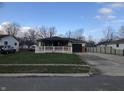 Inviting home with a covered front porch and garage, showcasing a well-maintained lawn at 127 Brunswick Dr, Greenwood, IN 46143