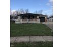 Single story house with covered front porch and attached garage. Green lawn at 127 Brunswick Dr, Greenwood, IN 46143