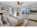 Serene bedroom with a ceiling fan, large window, neutral decor, and ensuite bathroom access at 13381 N White Cloud Ct, Camby, IN 46113
