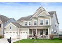 Beautiful two-story home with a three-car garage, covered porch, and well-maintained landscaping at 15046 Sullivan Ln, Westfield, IN 46074