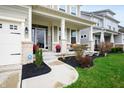 View of the home's entrance, showing covered porch, manicured landscaping, and inviting curb appeal at 15046 Sullivan Ln, Westfield, IN 46074