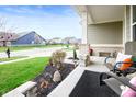 Inviting covered front porch with seating area, landscaping, and neighborhood street view at 15046 Sullivan Ln, Westfield, IN 46074
