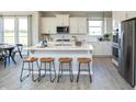 Bright kitchen featuring an island with seating, modern appliances, and ample cabinet space at 20342 Hudson Bay Ln, Westfield, IN 46074