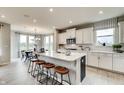 Open-concept kitchen with an island, pendant lighting, and a view into the dining area at 20342 Hudson Bay Ln, Westfield, IN 46074