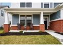 Inviting front porch with seating, brick columns, and a view of the entrance at 2156 W 171St St, Westfield, IN 46074