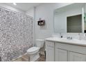 Well-lit bathroom with white vanity, framed mirror, and patterned shower curtain at 2208 Gambel Ln, Danville, IN 46122