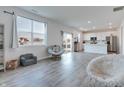 Bright living room featuring modern finishes, wood-look flooring and natural light from large windows at 2208 Gambel Ln, Danville, IN 46122