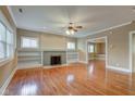 Spacious living room with hardwood floors, fireplace, built-in shelving, and natural light at 2620 Central Ave, Indianapolis, IN 46205
