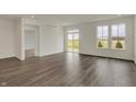 Spacious living room featuring stylish flooring, lots of natural light, and sliding glass door to patio at 268 Onset Way, Westfield, IN 46074