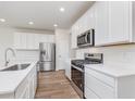 Modern kitchen featuring white cabinets, stainless steel appliances, and sleek countertops at 3308 Morab Dr, Zionsville, IN 46077