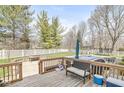 Spacious wooden deck with outdoor seating overlooking a backyard with a pool at 3998 Jonathan Rdg, Columbus, IN 47201