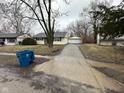Ranch-style home with detached garage and a long driveway at 4047 Biscayne Rd, Indianapolis, IN 46226