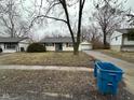 Traditional ranch-style home with detached garage and a well-maintained lawn at 4047 Biscayne Rd, Indianapolis, IN 46226