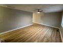 Spacious living room featuring new laminate floors, fresh paint, and a ceiling fan at 4047 Biscayne Rd, Indianapolis, IN 46226