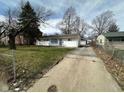 A one-story home shows off its large driveway and well-kept lawn in a quiet neighborhood at 4224 N Arlington Ave, Indianapolis, IN 46226