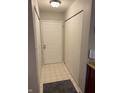 Welcoming entryway featuring a large front door, neutral tile flooring, and ample closet space at 4480 Village Ln # 2, Indianapolis, IN 46254