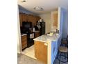 Efficient kitchen featuring modern appliances, light countertops, and wood cabinetry at 4480 Village Ln # 2, Indianapolis, IN 46254
