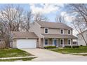 Attractive home showcasing a two-car garage, landscaped front yard, and a welcoming covered porch at 464 Hyannis Dr, Avon, IN 46123