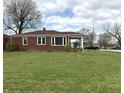 Side view of brick home with green lawn; bright, sunny day at 5368 Southeastern Ave, Indianapolis, IN 46203