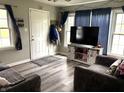 Cozy living room featuring wood-look floors and updated decor at 5368 Southeastern Ave, Indianapolis, IN 46203