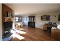 Inviting living area featuring gleaming hardwood floors, a cozy fireplace, and ample natural light at 5819 Bar Del E Dr, Indianapolis, IN 46221
