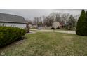Neighborhood street view with well-maintained lawns and mature trees in a quiet residential area at 7352 Crickwood Pl, Indianapolis, IN 46268