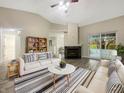 Bright living room with vaulted ceilings, fireplace, and sliding door access to the outdoors at 7850 Park North Bnd, Indianapolis, IN 46260