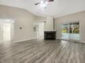 Spacious living room featuring hardwood floors, a fireplace, and sliding glass doors to the patio at 7850 Park North Bnd, Indianapolis, IN 46260